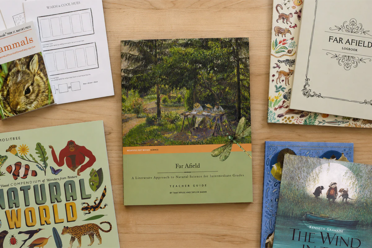 Collection of books and homeschool materials on a wooden surface for Far Afield Natural Science study